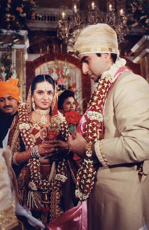 A man and a woman are getting married in an indian ceremony.