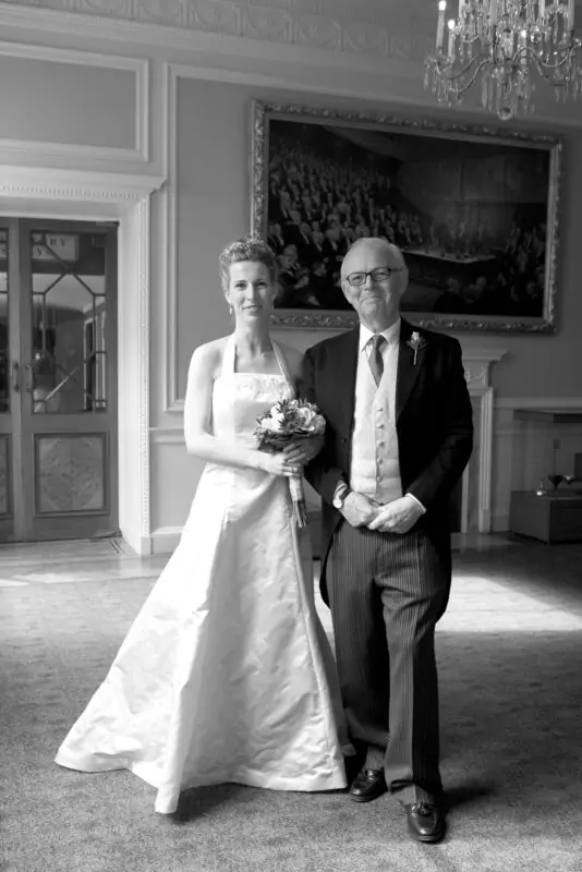 A black and white photo of a bride and her father.