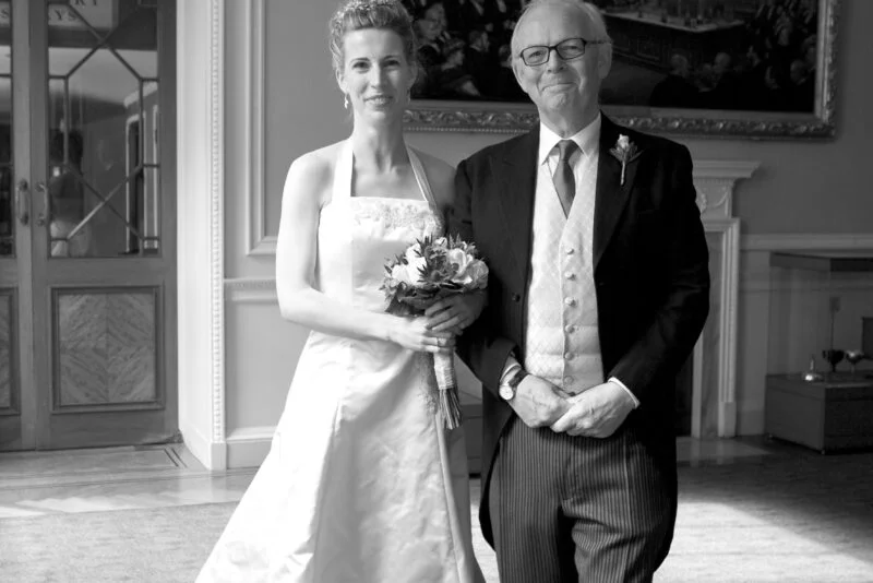 A black and white photo of a bride and her father.