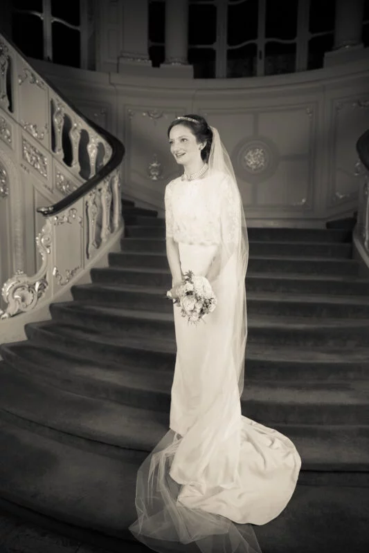 A fine art wedding photographer capturing a bride on a London staircase.