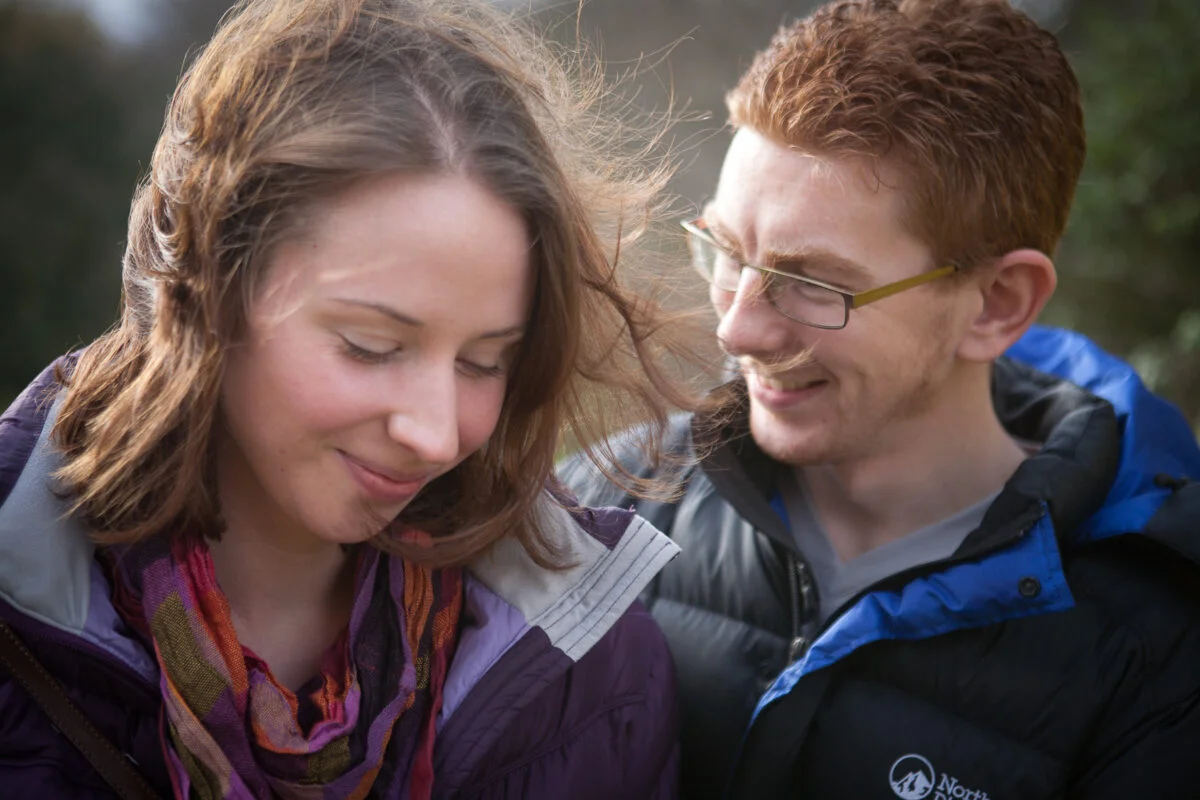 A man and a woman looking at a cell phone.