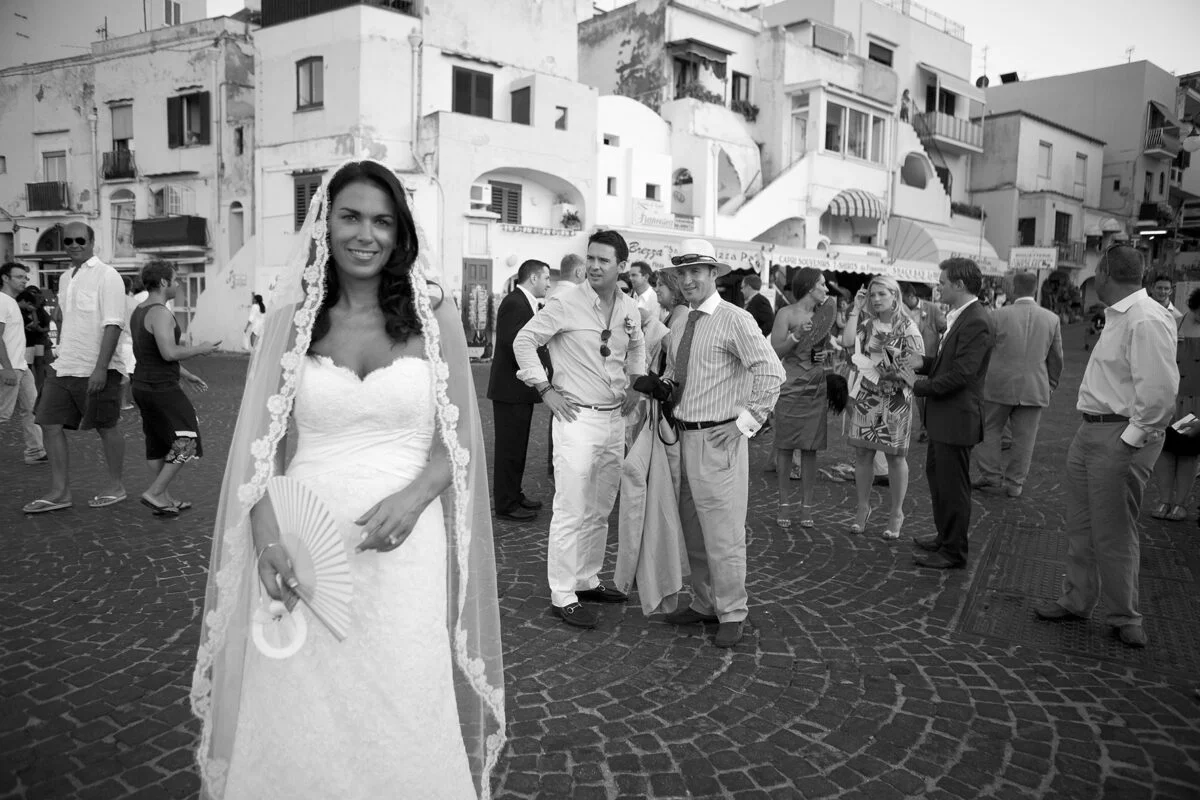 A bride is standing in front of a crowd of people.