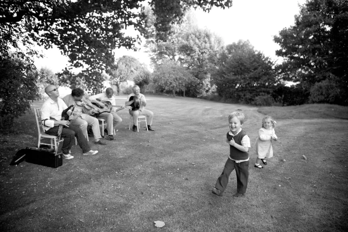 A black and white photo of a group of people in a field.