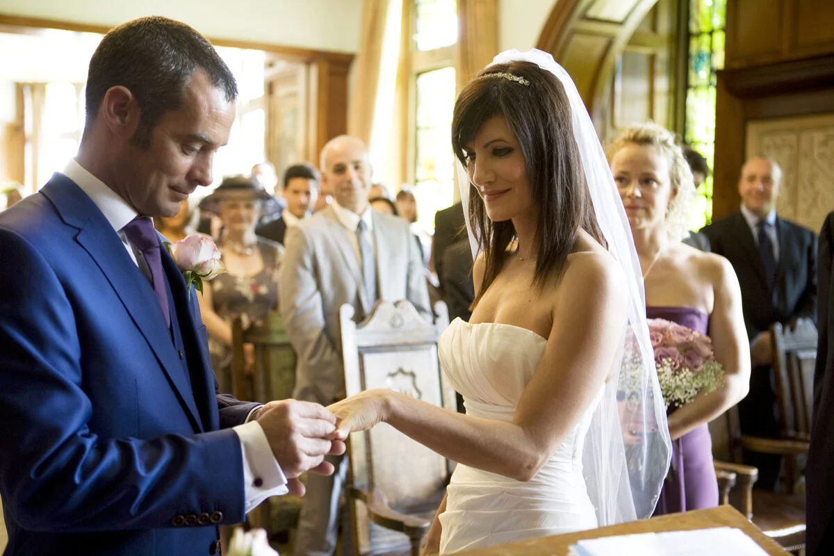 A bride and groom exchanging their wedding rings.