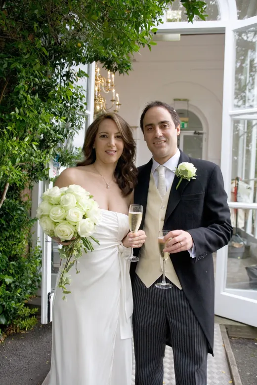 A fine art wedding photographer captures a man and a woman in London, dressed in wedding attire.
