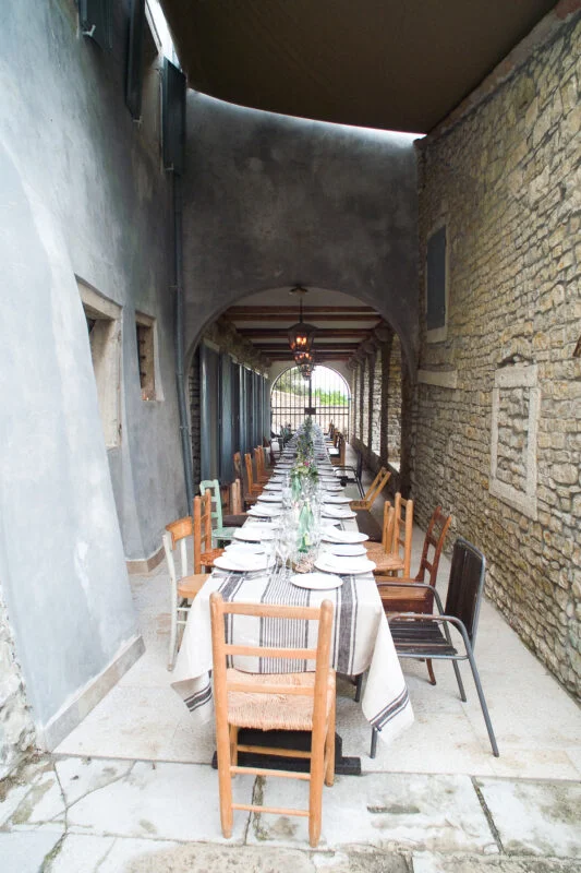 A table is set up in a stone building.