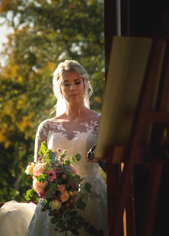 A woman in a white dress holding a bouquet of flowers.
