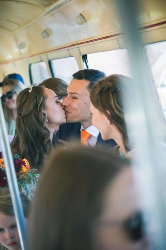 A group of people kissing on a train.
