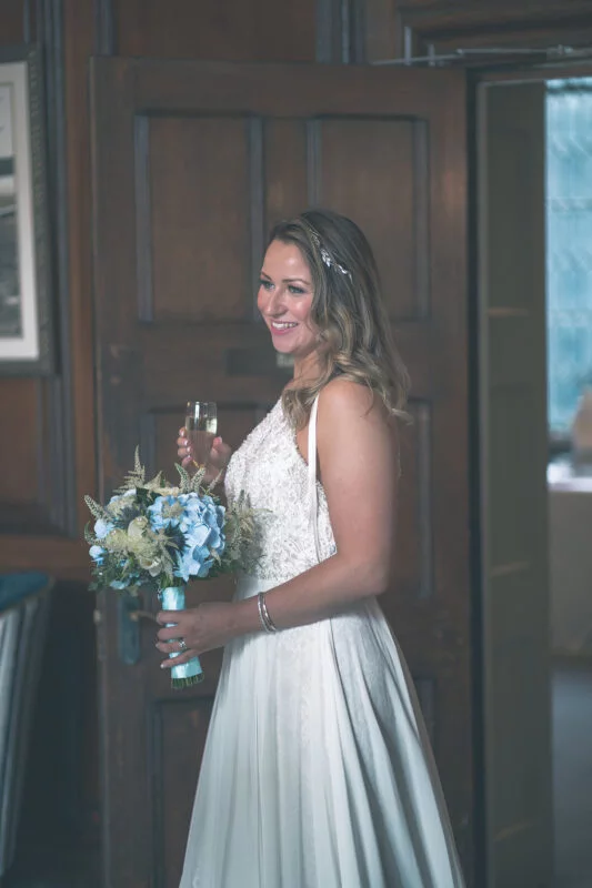A bride in a wedding dress holding a bouquet.