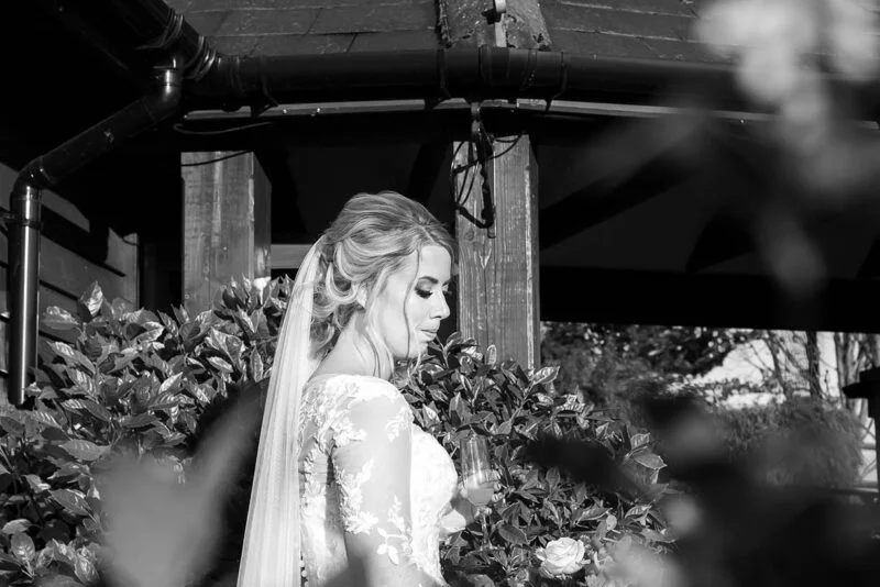 A bride and groom standing in front of a gazebo.
