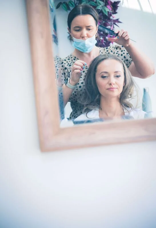 A woman is getting her hair done in a salon.
