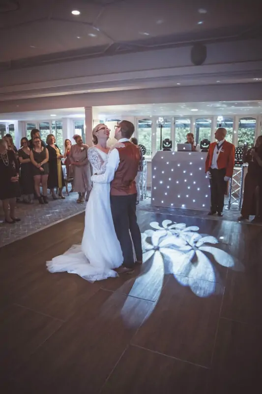 A bride and groom sharing their first dance at their wedding reception.