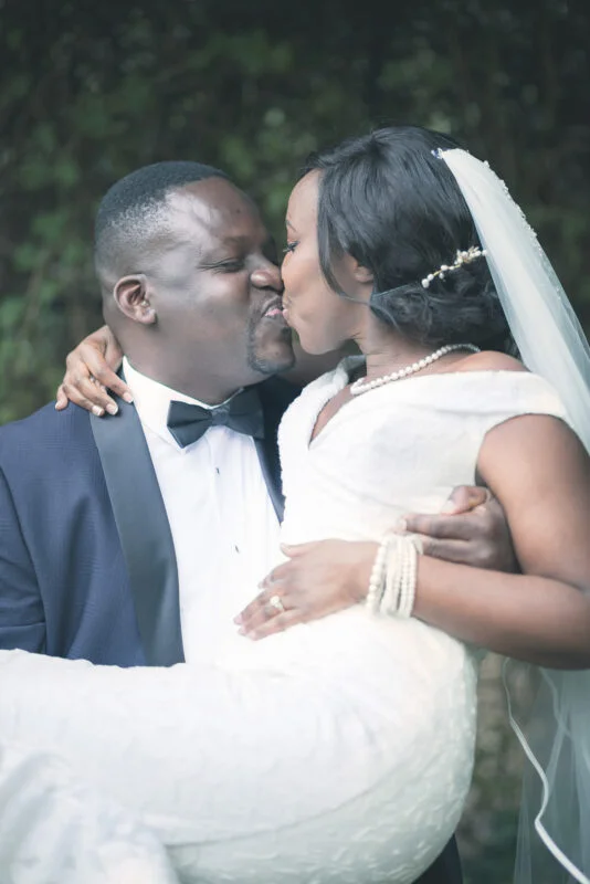 A bride and groom kissing on their wedding day.