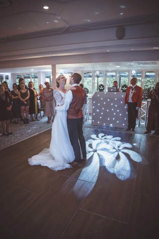 A bride and groom sharing their first dance at their wedding reception.