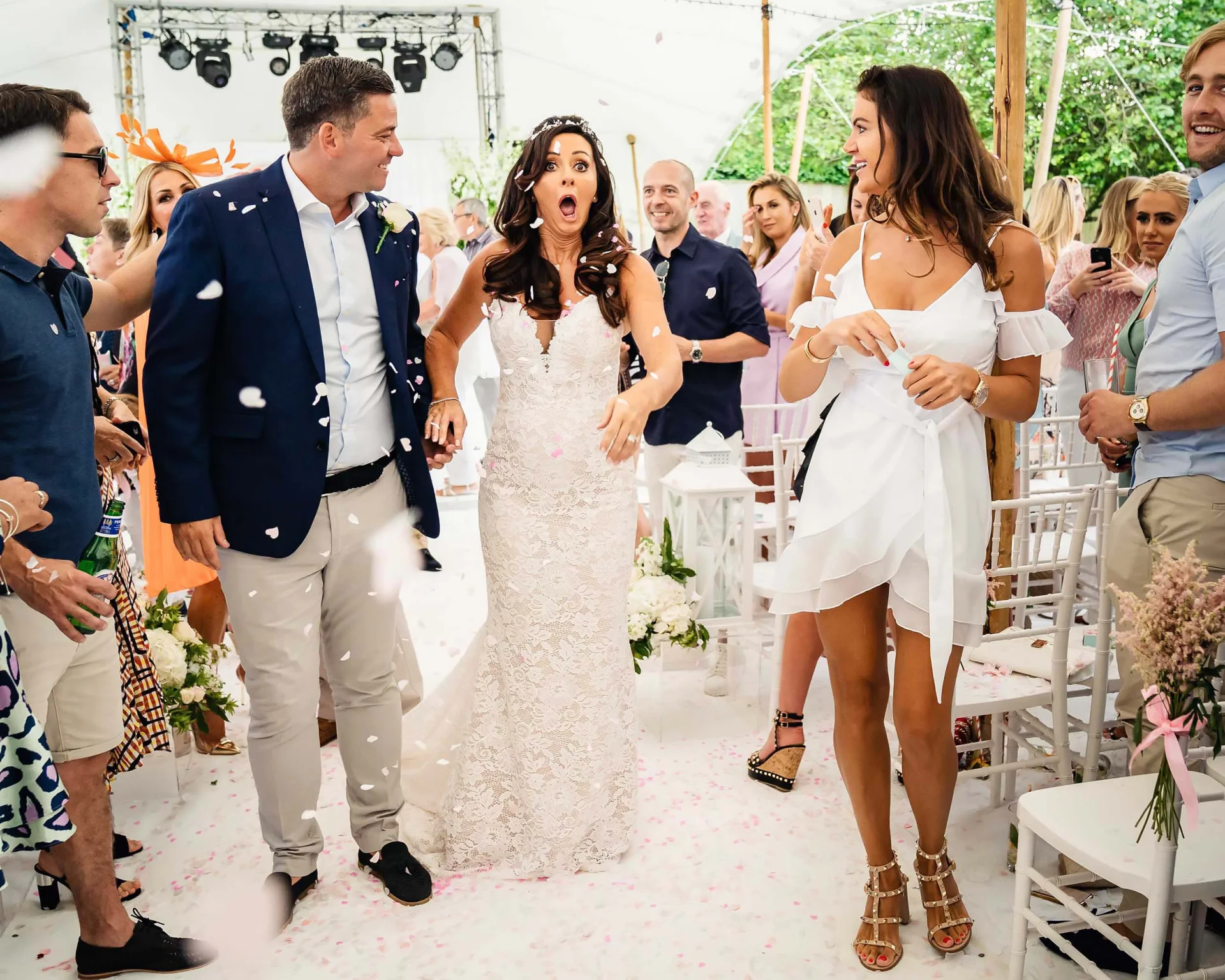 A bride and groom walk down the aisle with affordable wedding photographer capturing their London ceremony. (listing)