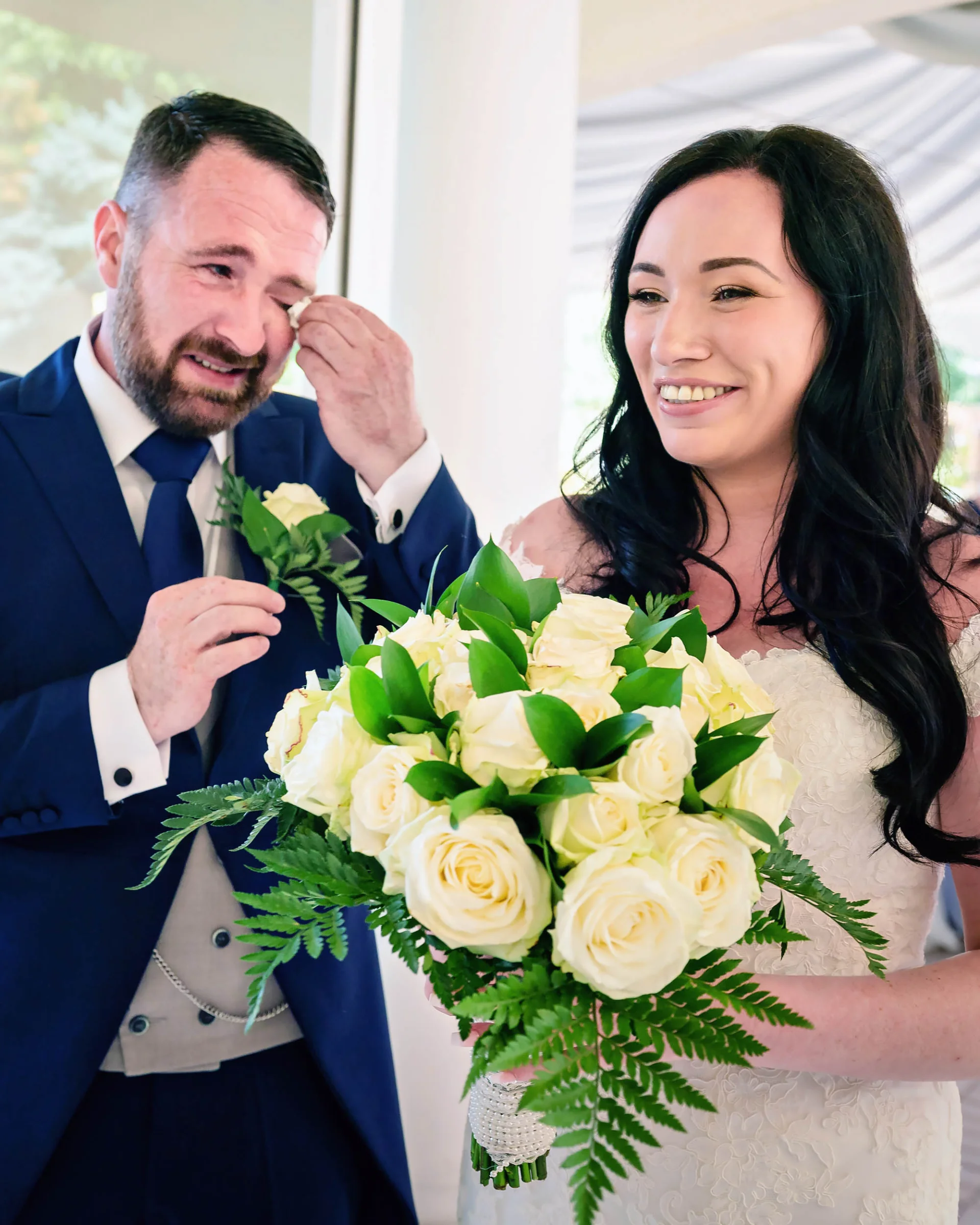 A man wearing a blue suit at a wedding in London. (listing)
