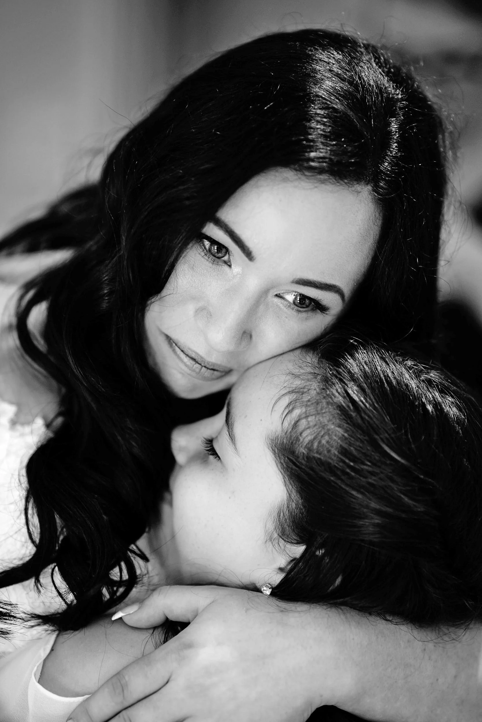 A mother-daughter embrace captured in a cost-effective monochrome photograph by a skilled London photographer. (listing)