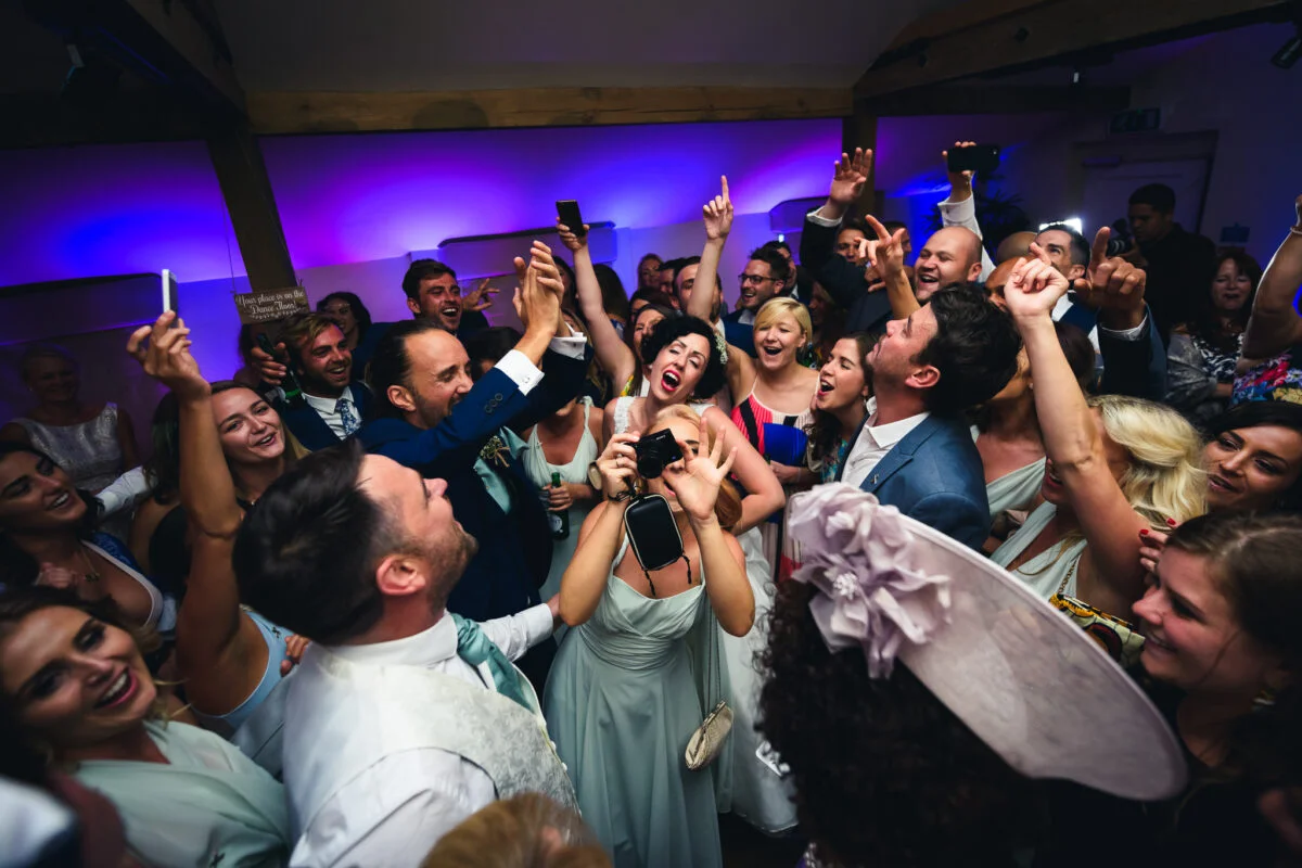 A group of people celebrating at a wedding.