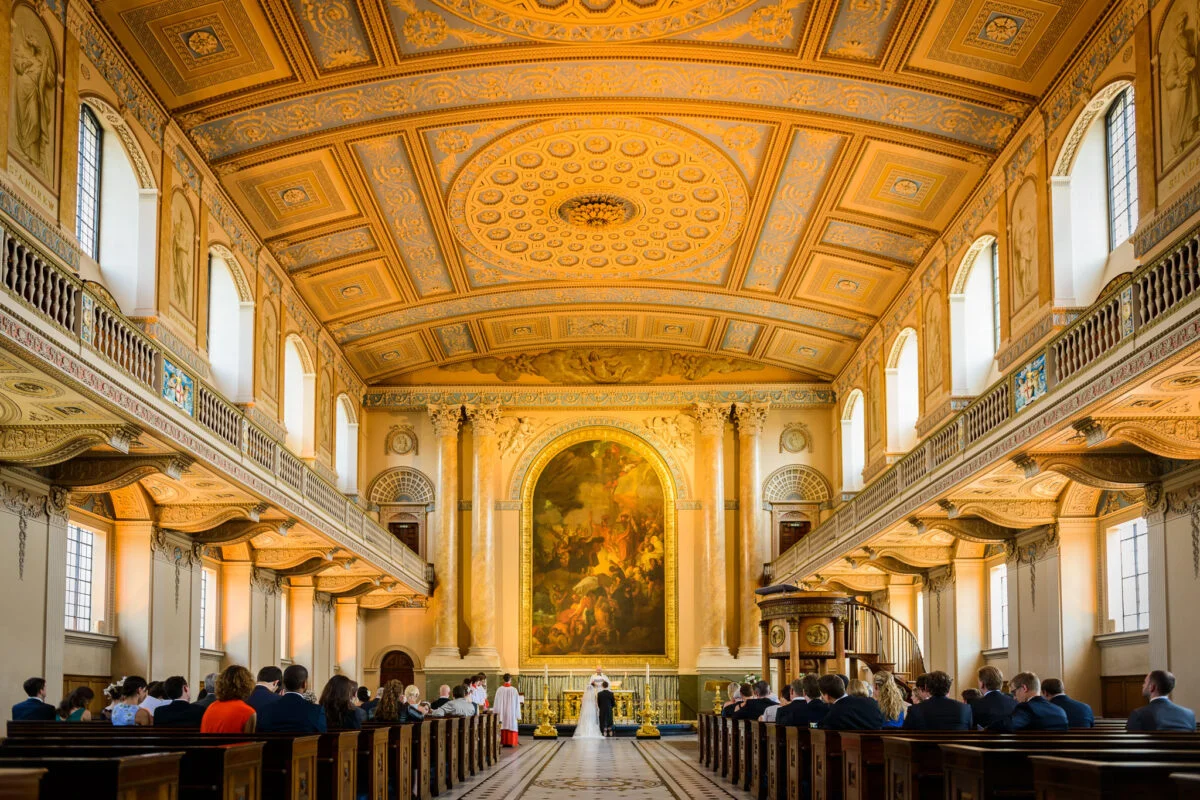A wedding ceremony in a large church with pews.