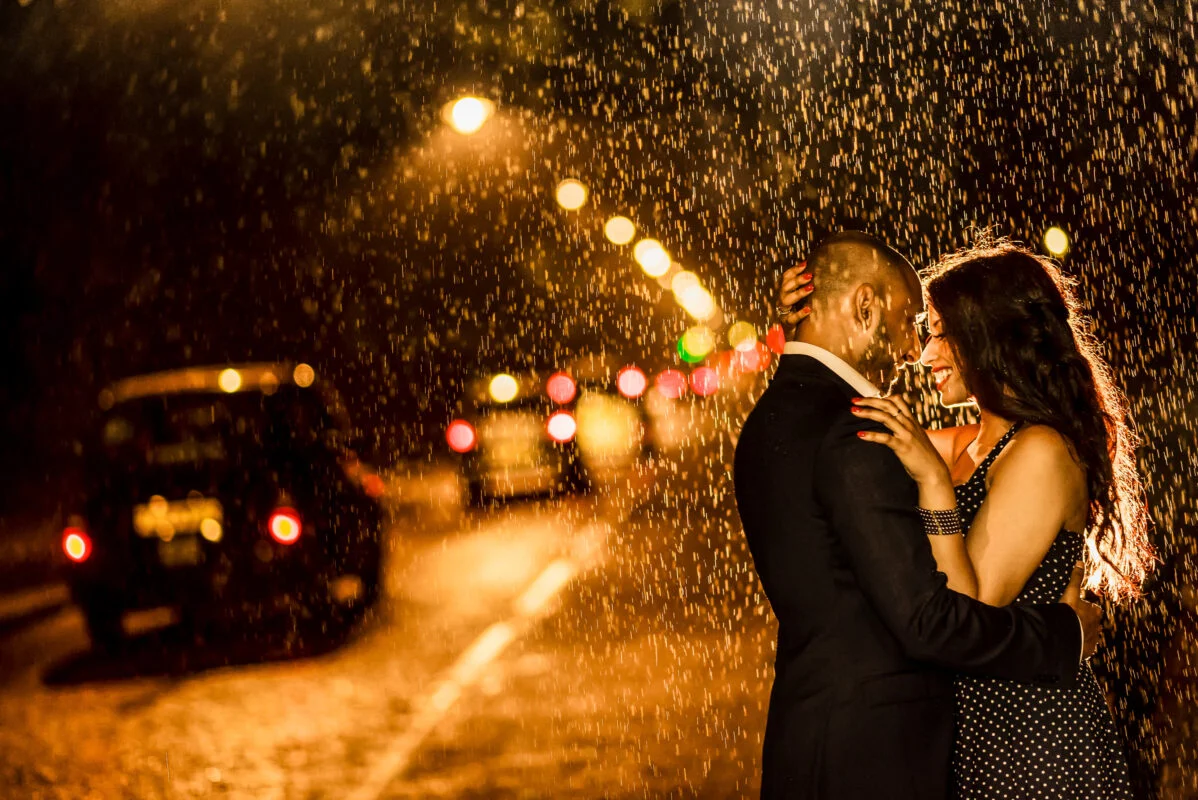 A couple kissing in the rain in london.