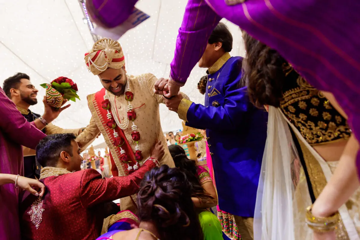 A group of indian brides and grooms at a wedding ceremony.