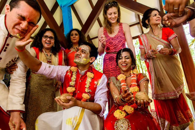 A group of people are gathered around a table for a wedding ceremony.