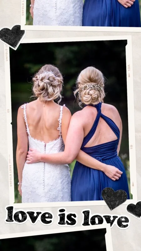 Two brides are holding each other with the words love is love.