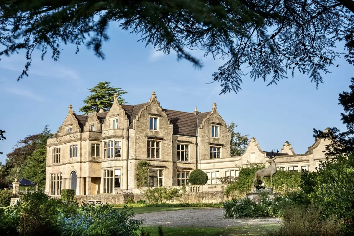 A large mansion in the middle of a lush garden.