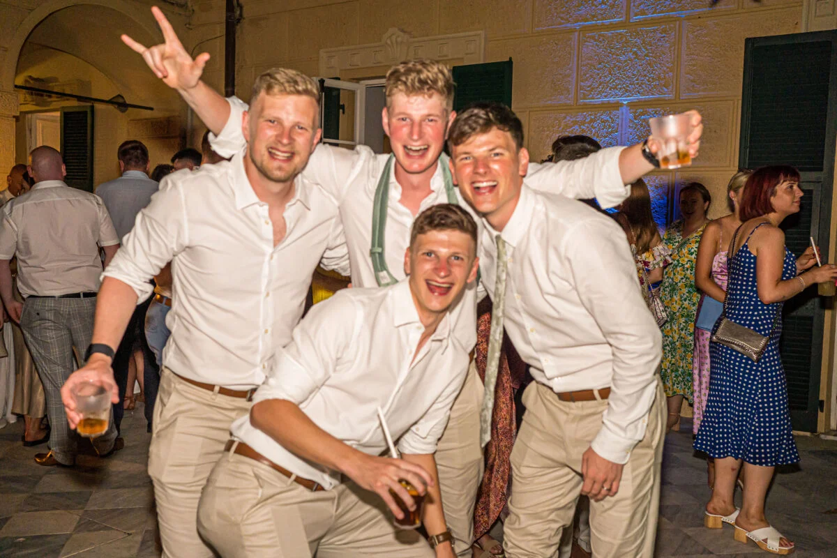 A group of men posing for a photo at a party.