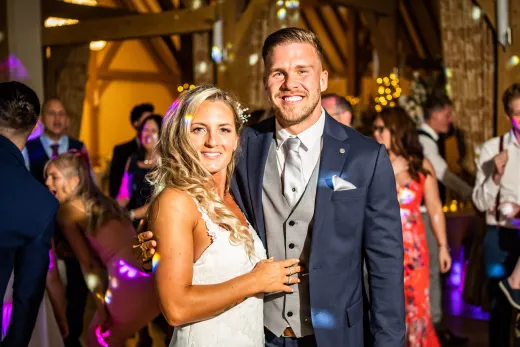 A bride and groom posing for a photo at their wedding reception captured by the best wedding photographer in Bristol.