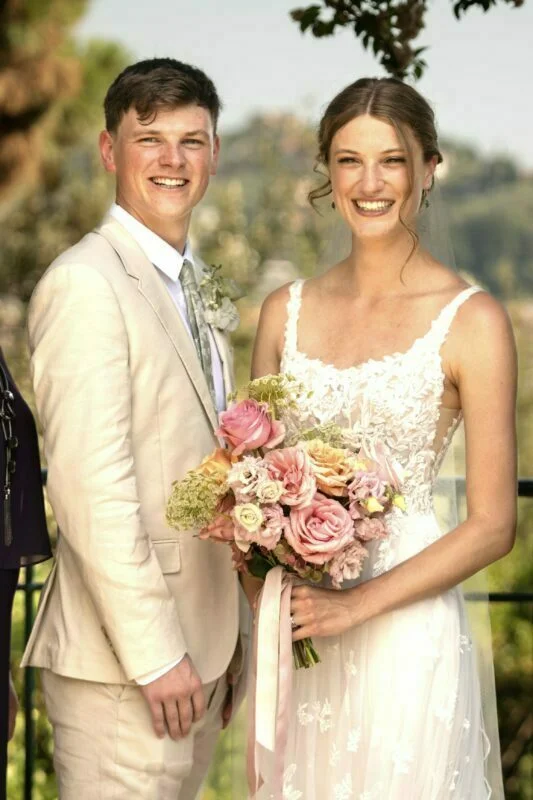 A bride and groom posing for a photo.