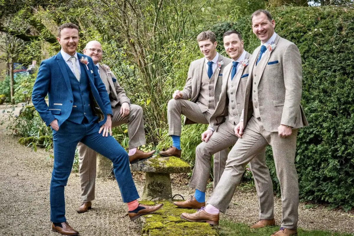 A group of groomsmen posing for a photo.
