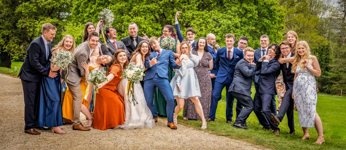 A group of wedding party posing for a photo.