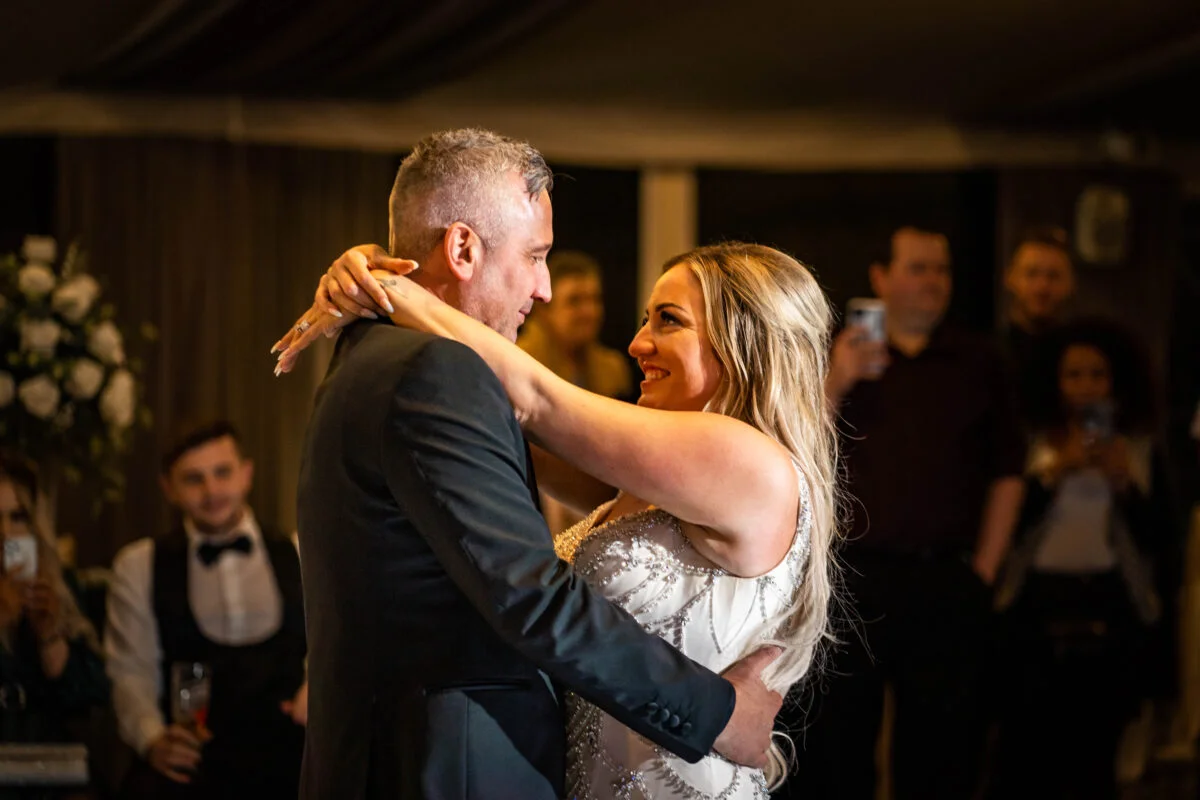 A bride and groom sharing their first dance at their wedding reception.