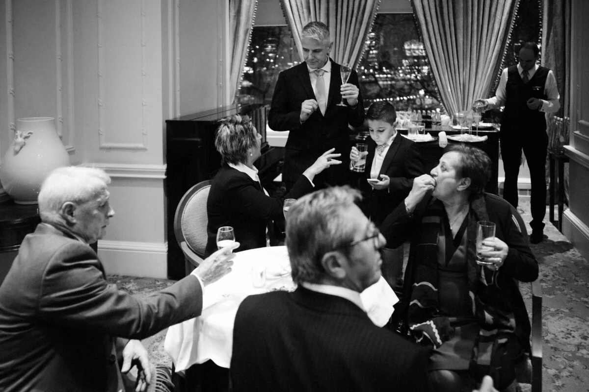 A black and white photo of a group of people at a table.