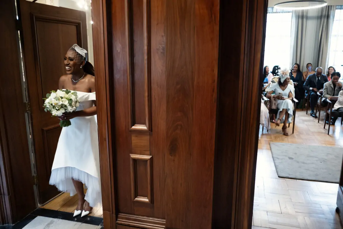 A bride is walking down the aisle at a wedding.