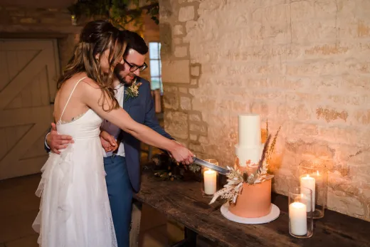 A bride and groom cutting their wedding cake.