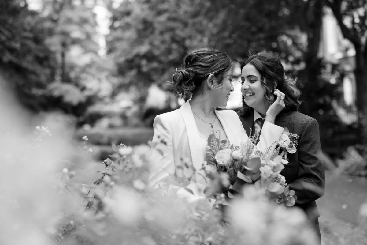 A black and white photo of two women in a garden.