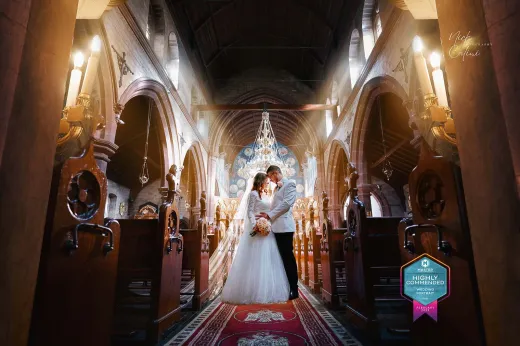 A bride and groom standing in a church.