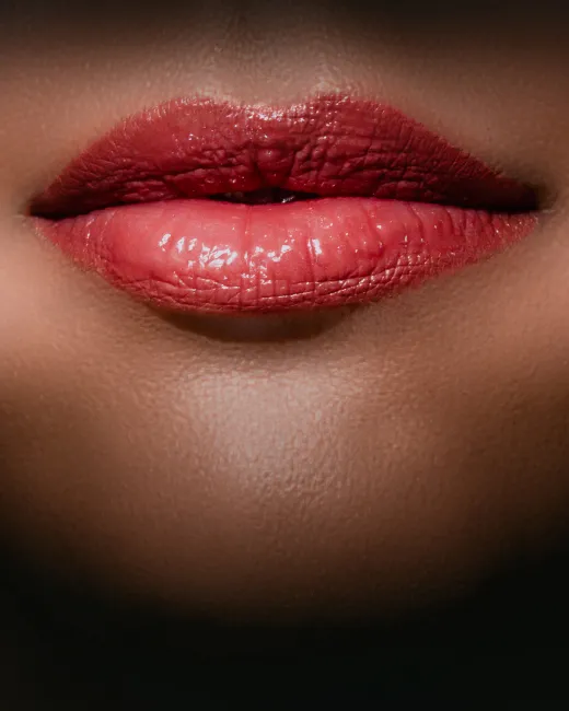 A close up of a woman's lips with red lipstick.