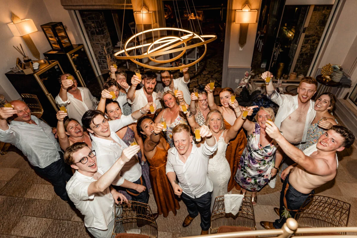 A group of people holding champagne glasses at a wedding reception.