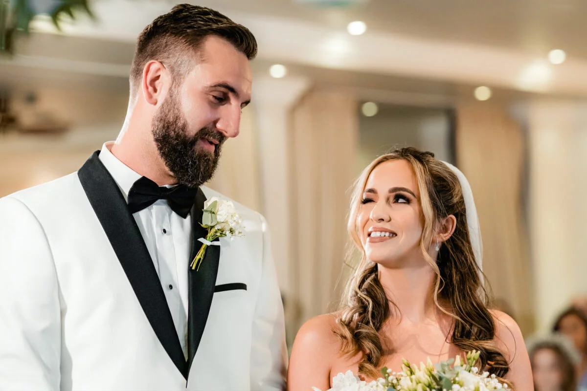 A bride and groom look at each other during their wedding ceremony.