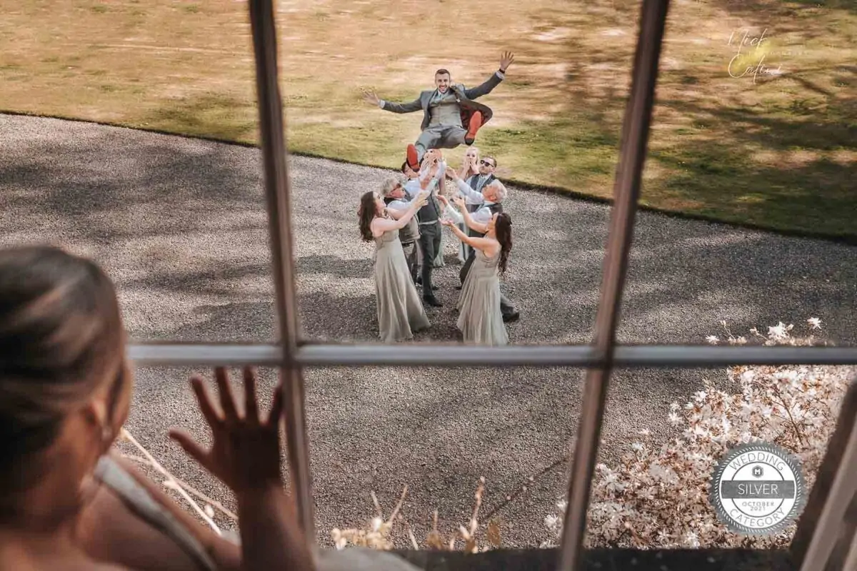 A group of bridesmaids standing in front of a window.