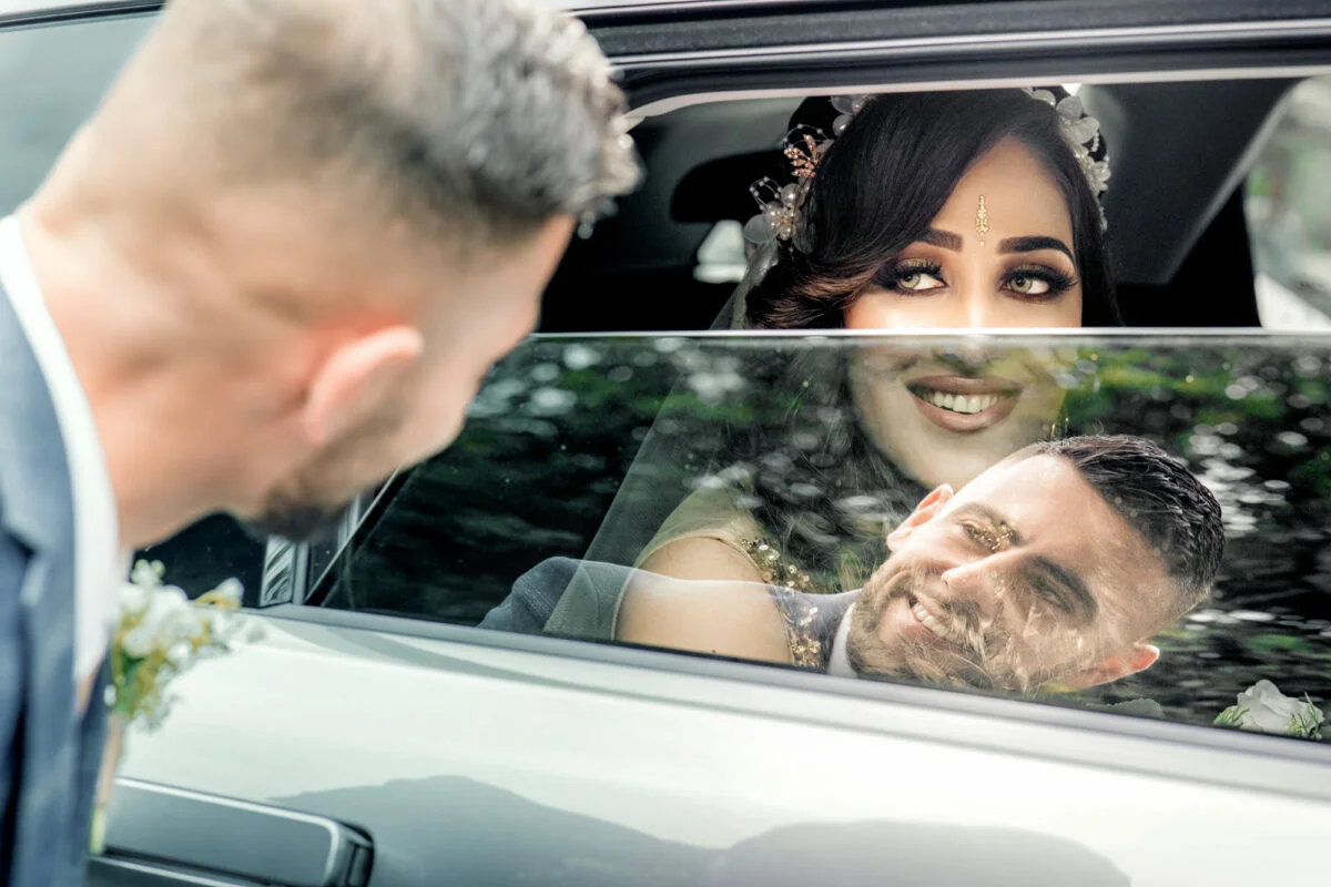 A bride and groom in a car.