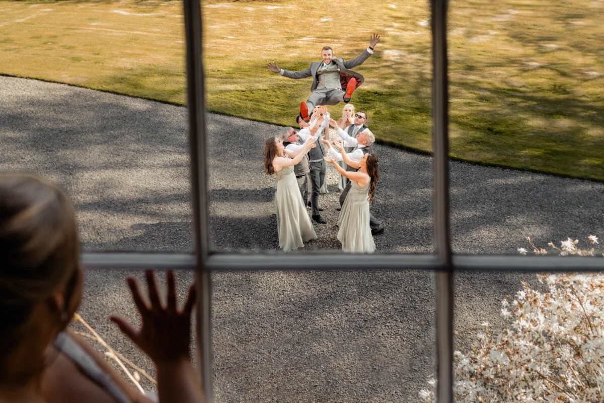 A group of bridesmaids standing in front of a window.