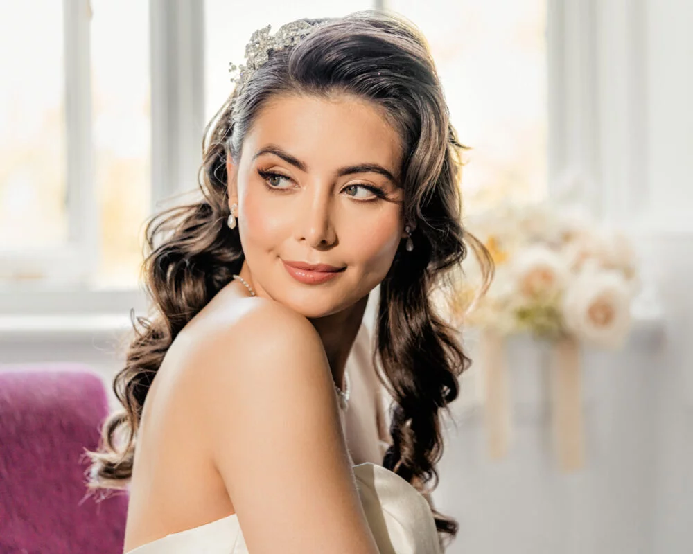 A bride in a wedding dress posing for a photo.