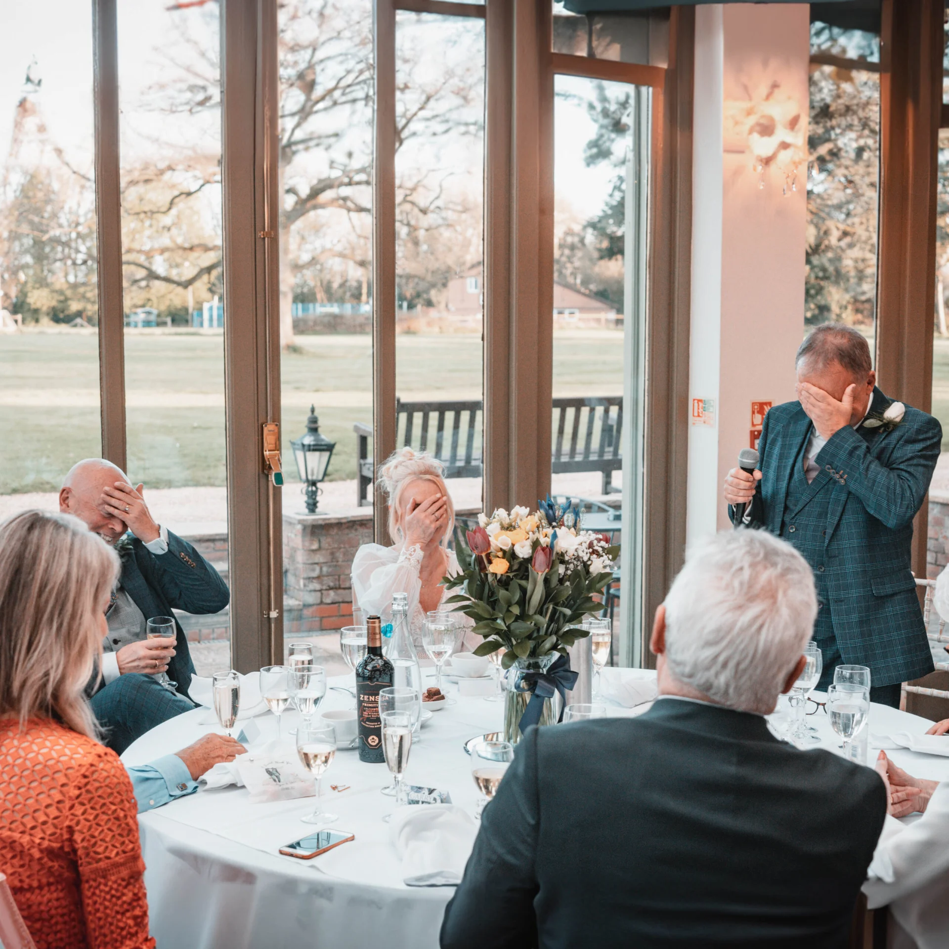 A group of people sitting around a fairytale wedding table. (listing)