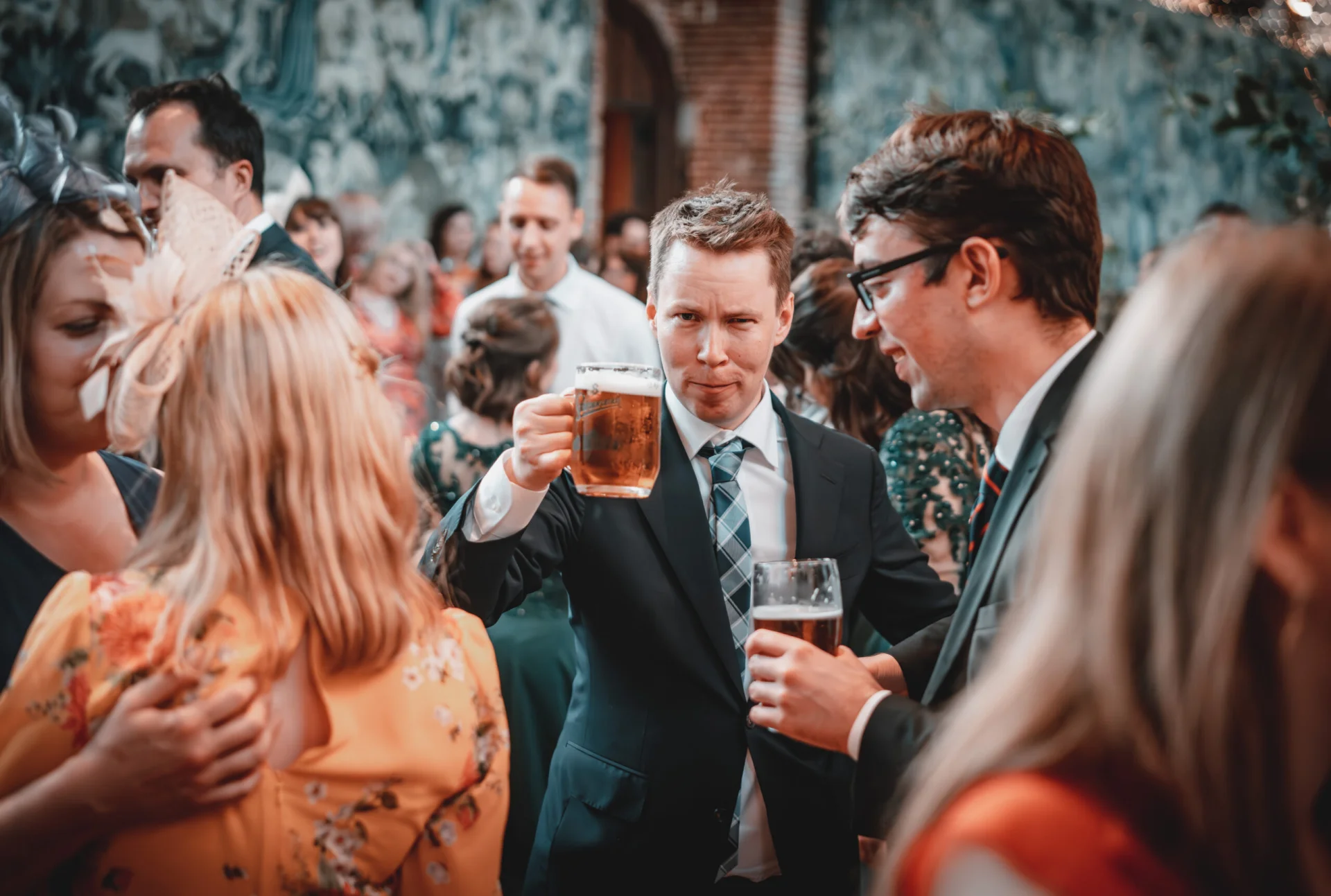 A group of people enjoying beer at a fairytale wedding reception. (listing)