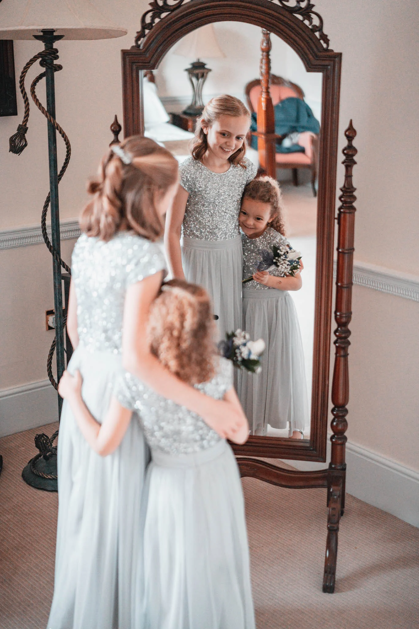 Fairytale bridesmaids standing in front of a mirror. (listing)