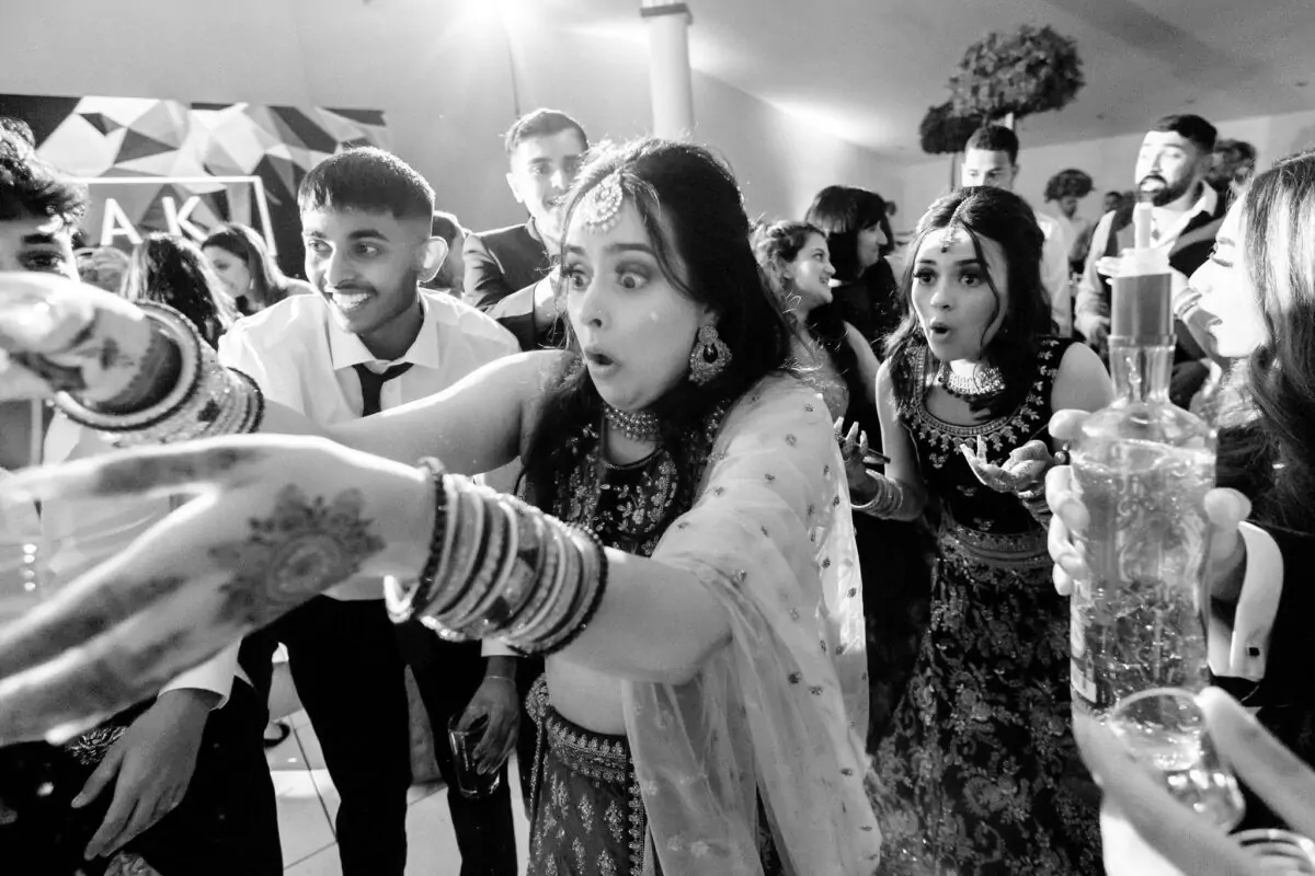 Black and white photo of a group of people at a wedding.
